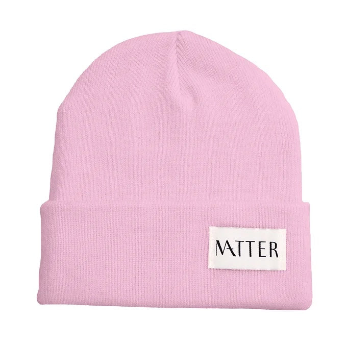 Pale pink knit beanie with turned-up brim and woven Matter label on front