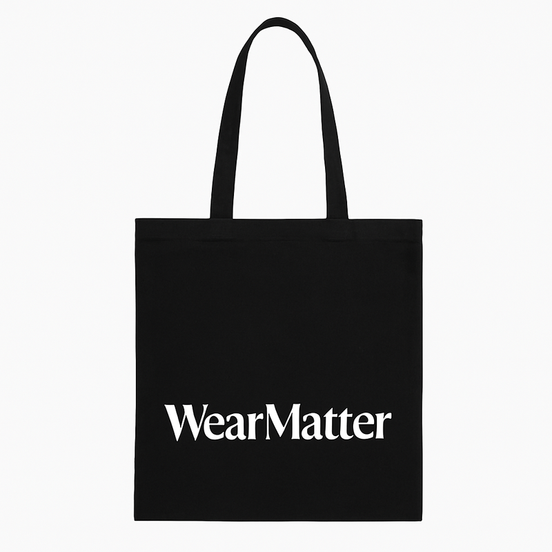 A black tote bag with 'WearMatter' printed in white on the side.