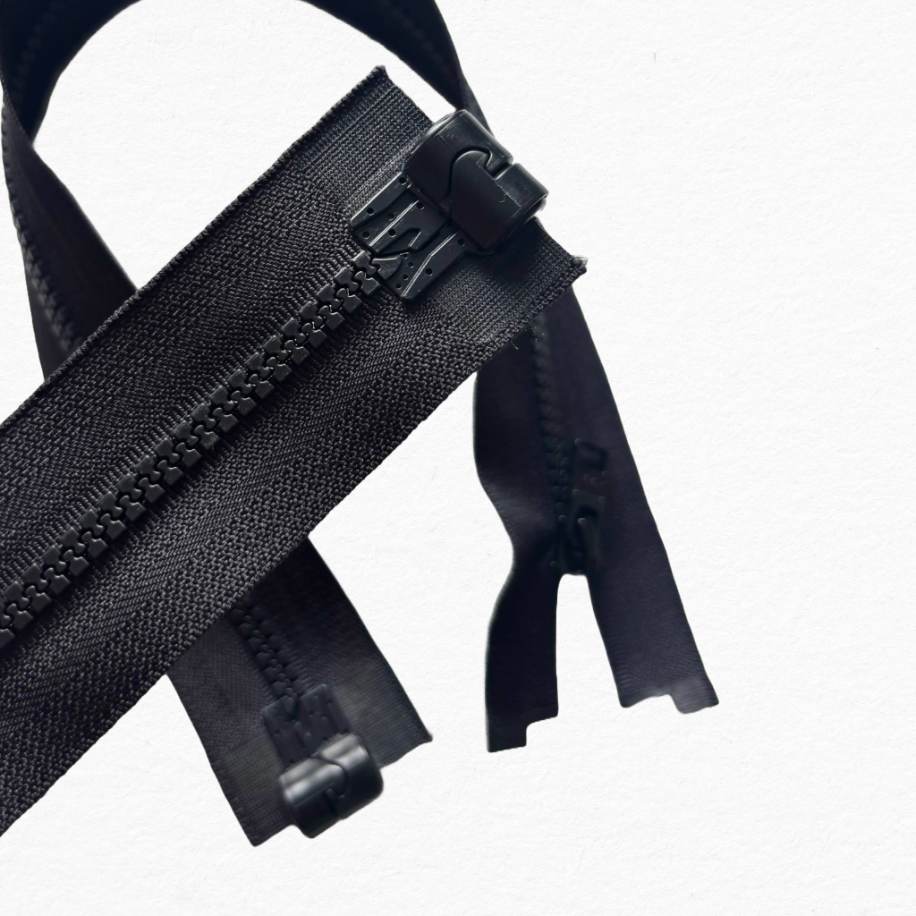 Close-up of black magnetic zippers on a white background