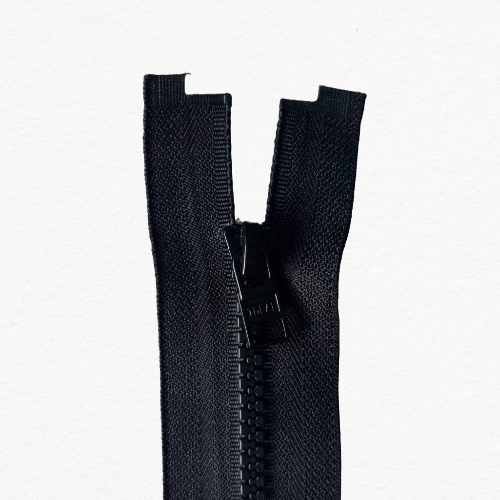 Black magnetic zipper on a white background. Showing the top detail