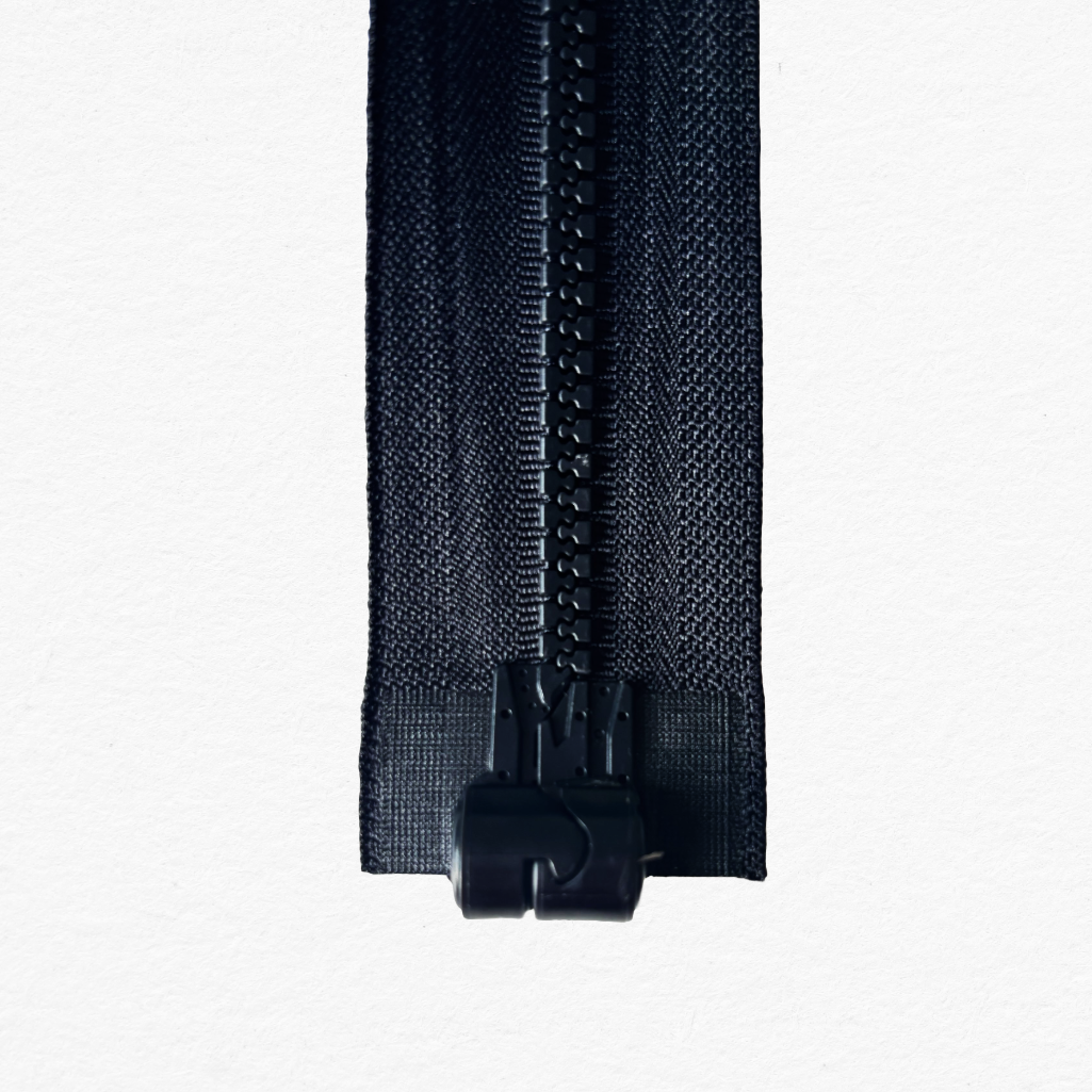 Close-up of black magnetic closure zipper on a white background. zip is closed