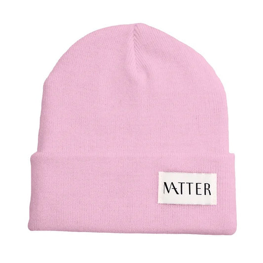 Pale pink knit beanie with turned-up brim and woven Matter label on front
