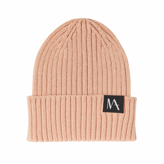 Pinky peach beanie with a black logo patch on a white background