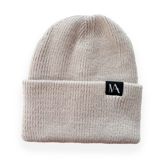 Sand coloured ribbed knit beanie with black WearMatter label on folded brim